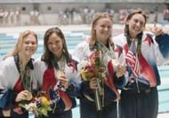 Jenny Thompson along with her teammates Angel Martino, Catherine Fox, and Amy Van Dyken celebrate their victory in the Women's 4x100 meter freestyle relay race during the 1996 Olympics in Atlanta, Georgia. (Photo by Getty Images)